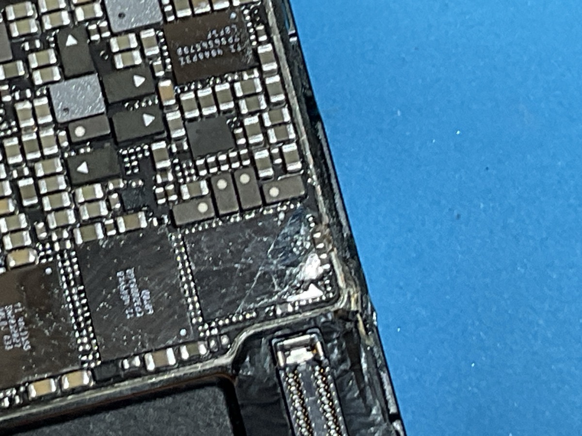 Cracked IC power chip on iPhone 16 Pro Max logic board under microscope - micro-soldering repair Marietta GA