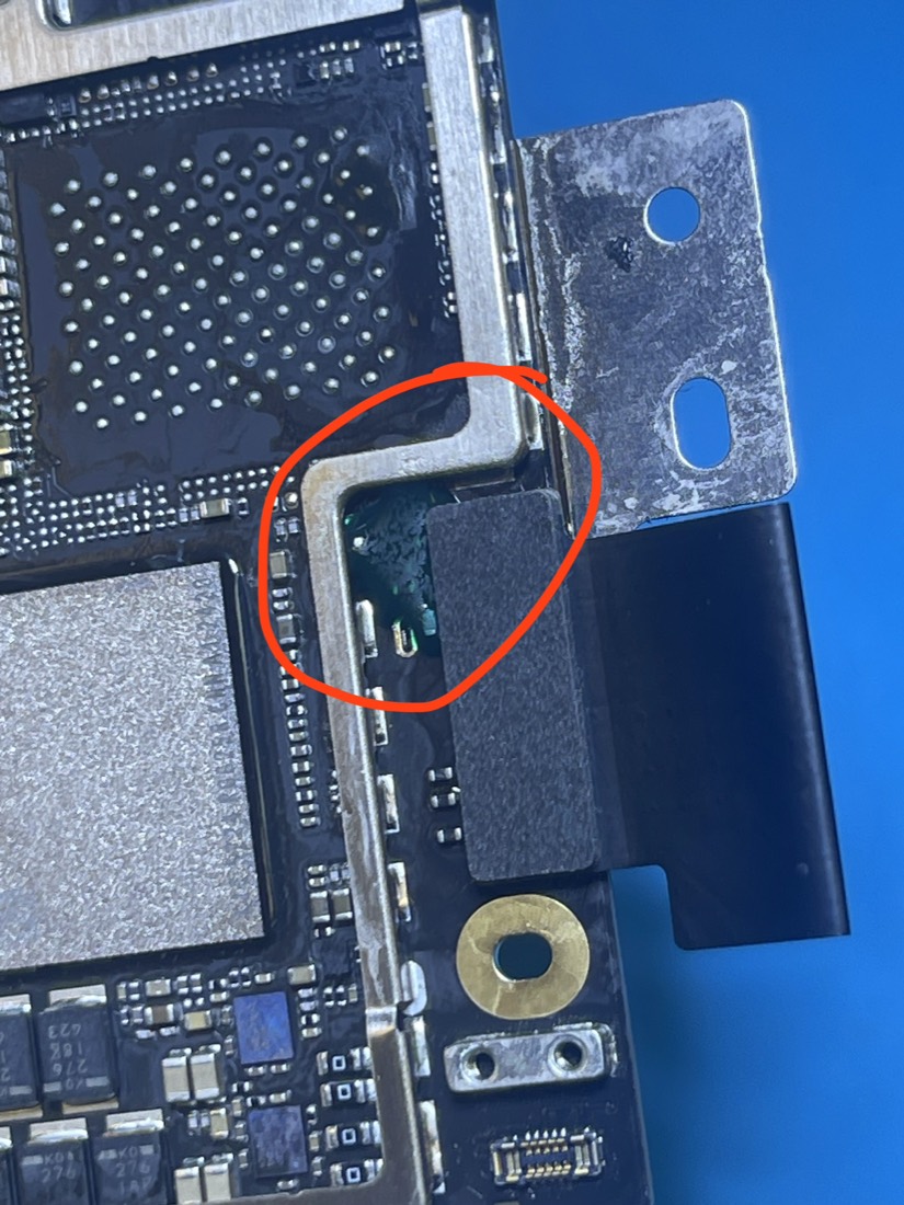 MacBook Air M2 A2681 logic board after repair: a new jumper line bridging the three capacitors to restore line voltage, sealed under green UV-cured epoxy