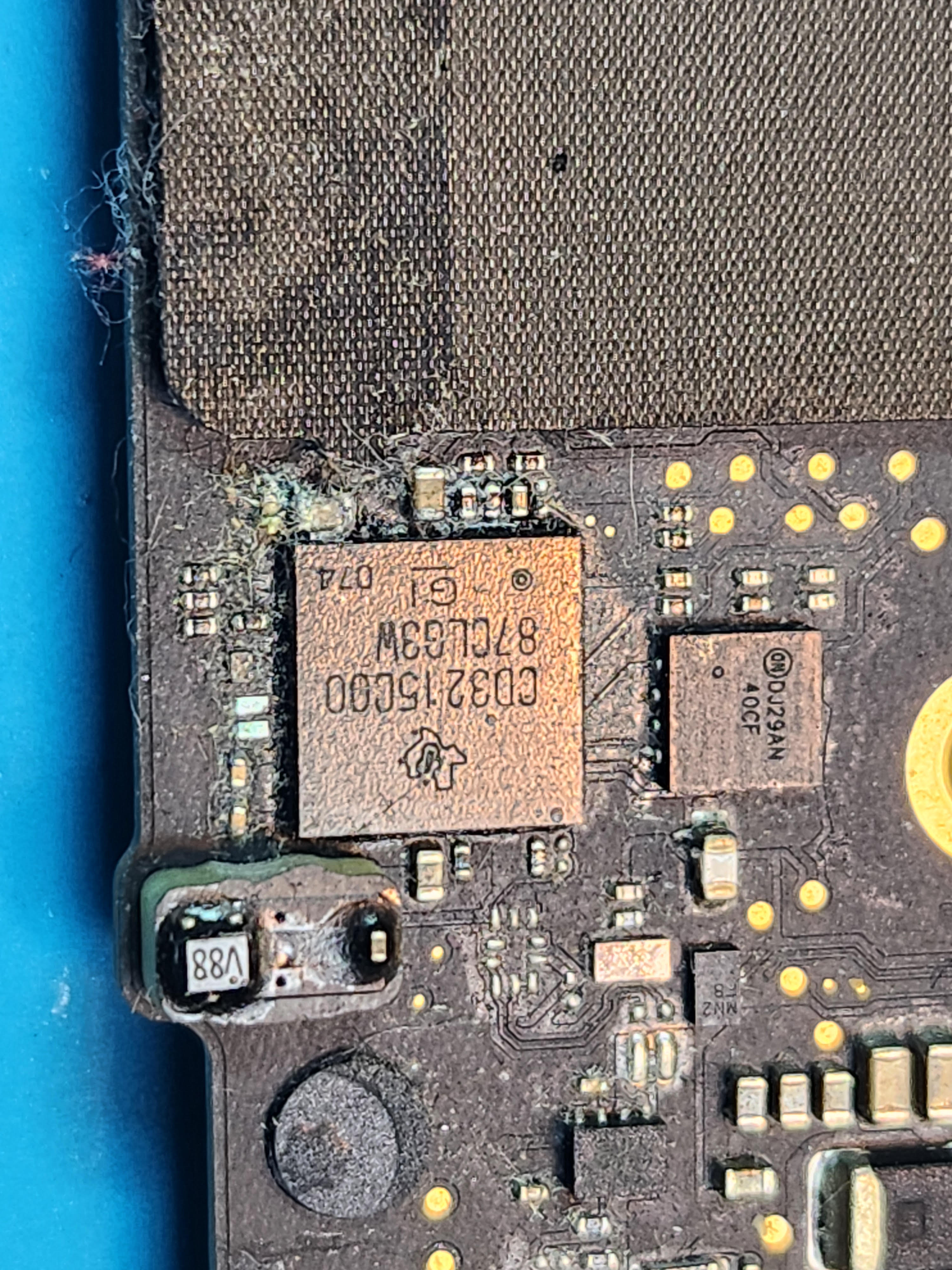 MacBook logic board with liquid damage corrosion before ultrasonic cleaning