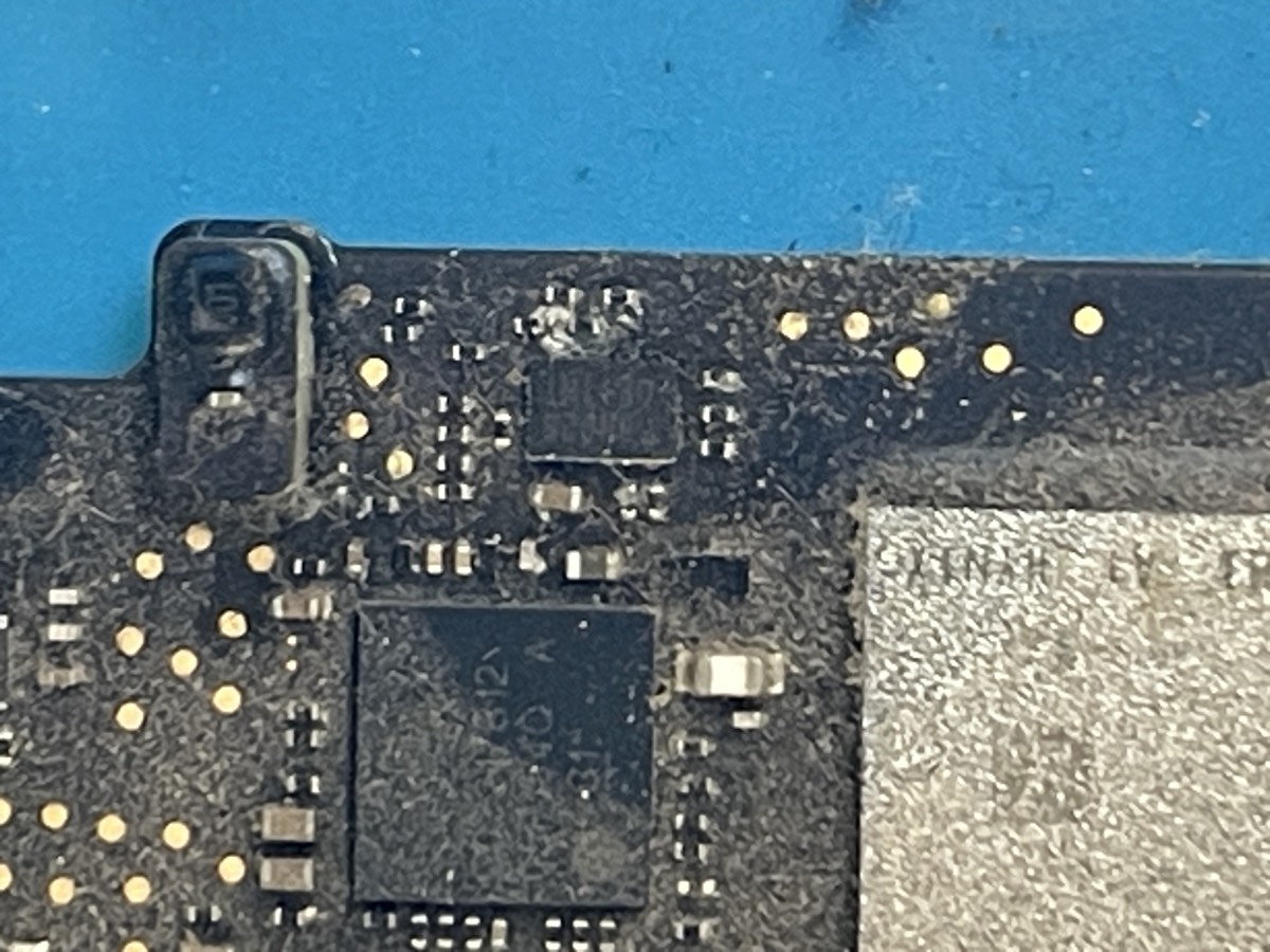 Corrosion from liquid spill on MacBook logic board at The Mac Space repair shop