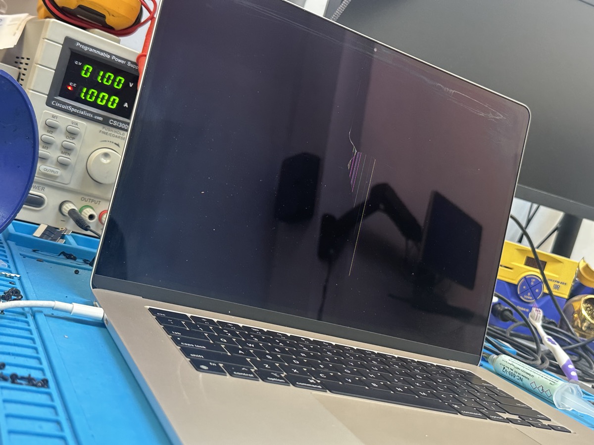 MacBook Pro with cracked LCD on repair bench at The Mac Space