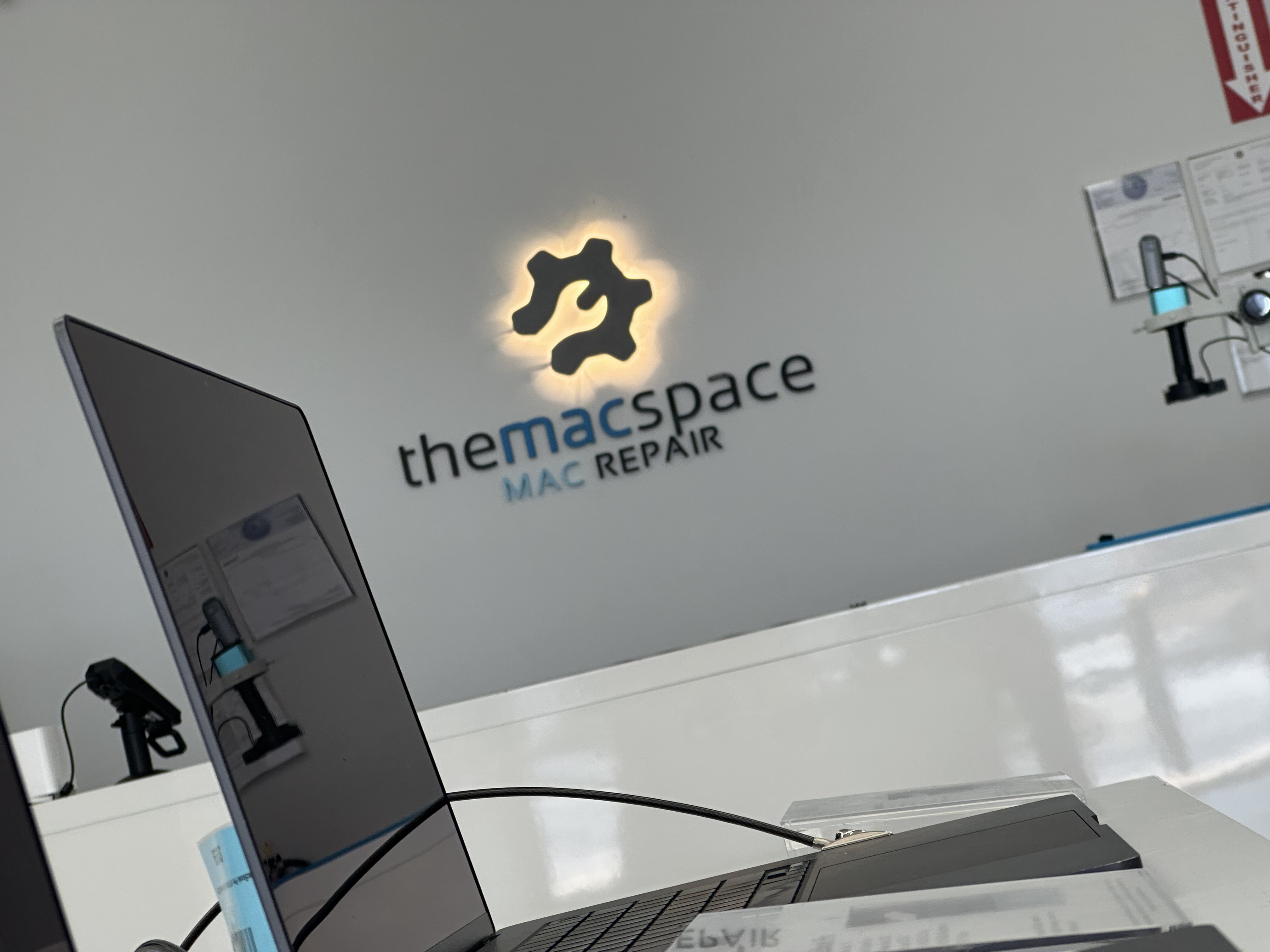 The Mac Space: Mac Repair shop in Marietta GA, backlit logo and repair counter serving Atlanta, Roswell, Kennesaw, and Smyrna